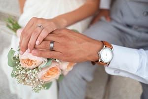 Recently married couple holding hands showing their rings
