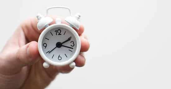 Man holding a small clock