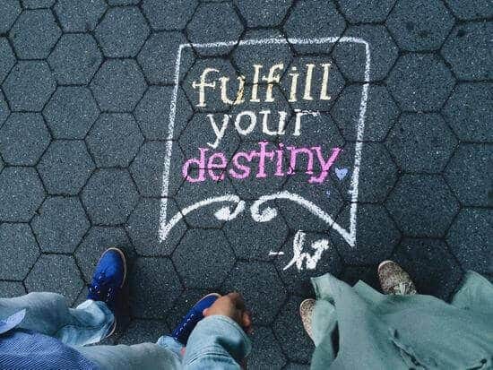 Sidewalk with the quote "fulfill your destiny" written in chalk